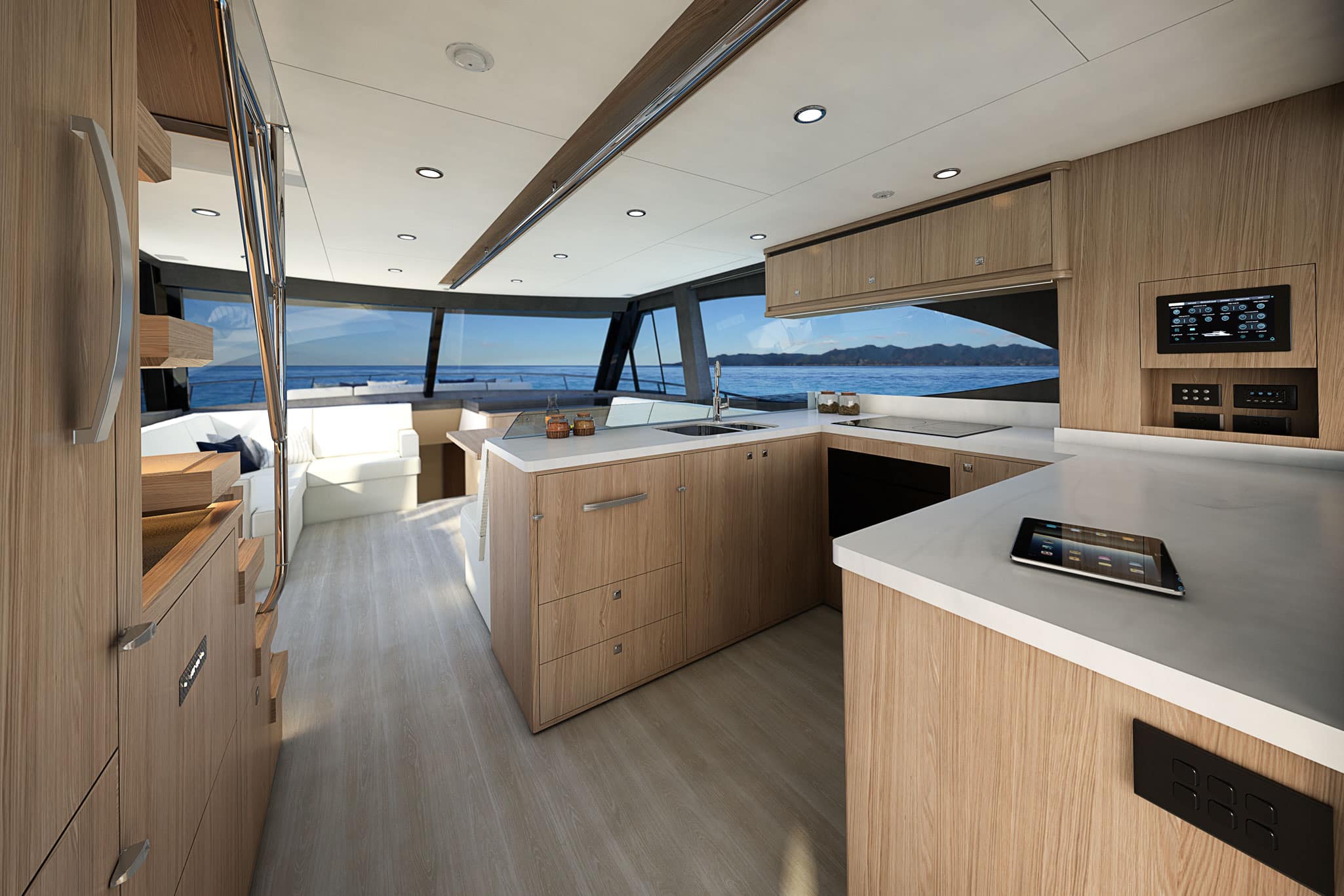 The gourmet galley has a full height refrigerator and features premium appliances beautifully integrated into handcrafted exotic timbers.