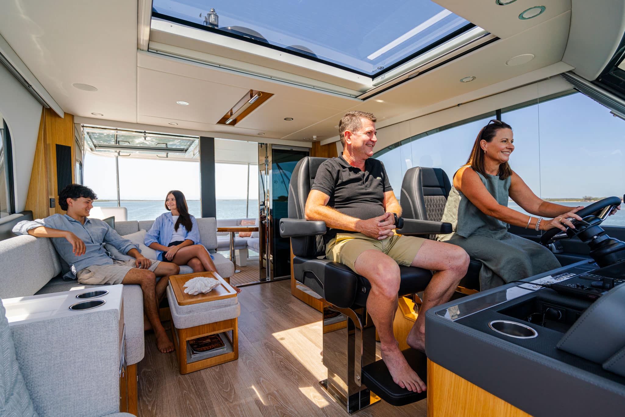 The fully enclosed flybridge aboard the 58 Sports Motor Yacht offers a state-of-the-art helm forward plus lounge aft.
