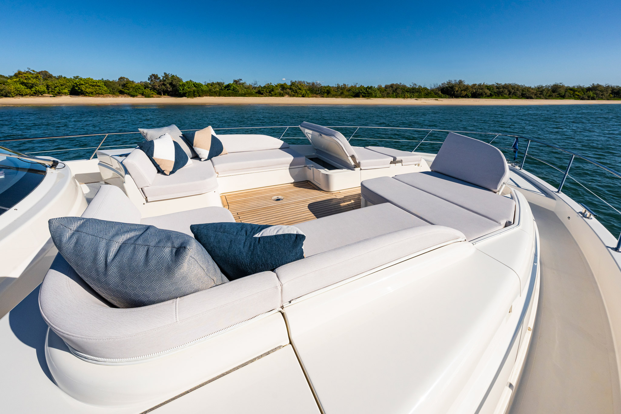 Casual and relaxed on 6800 forward deck with 8-seater lounge, premium sound system and twin sunbeds.