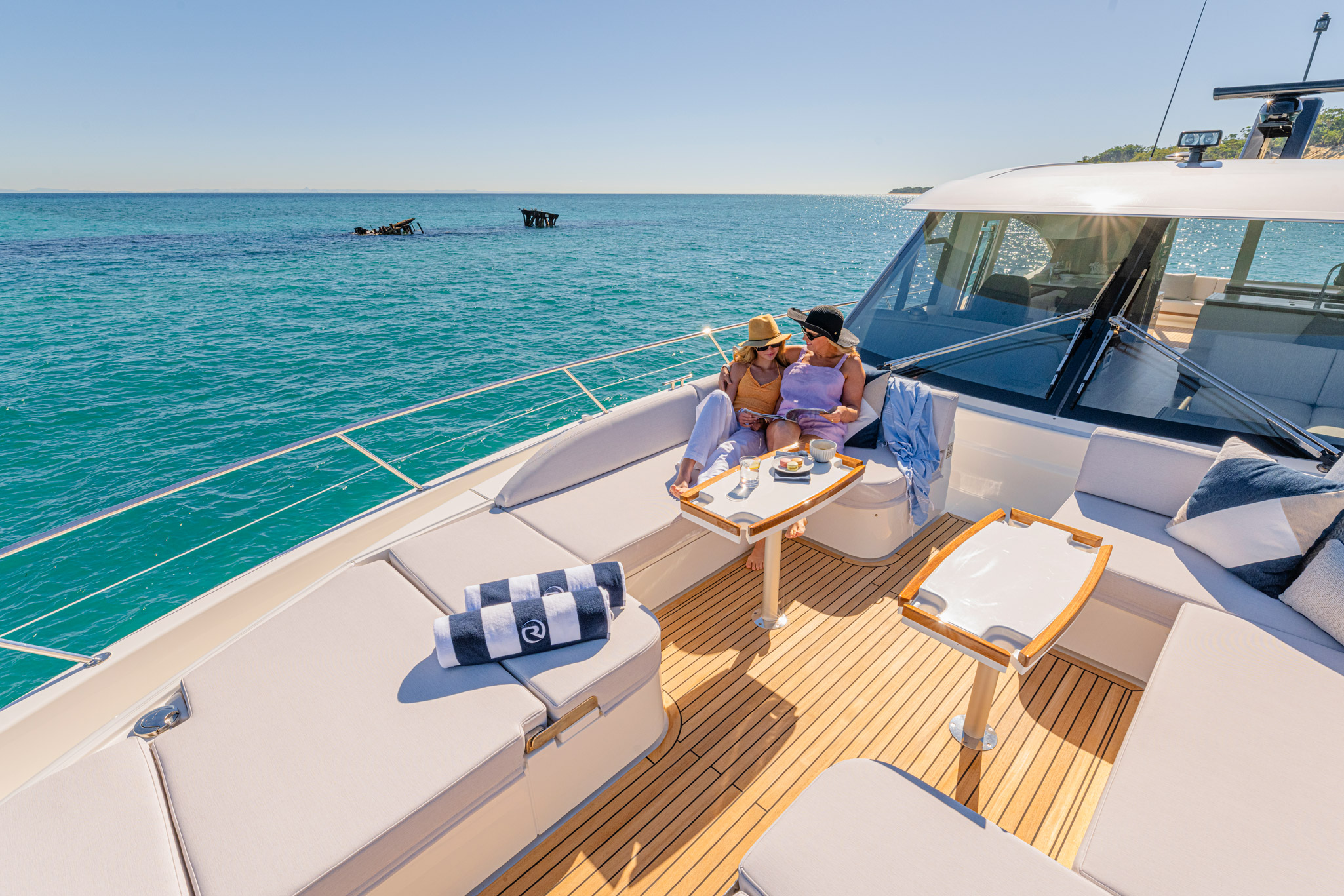 Casual and relaxed on 6800 forward deck with 8-seater lounge, premium sound system and twin sunbeds.