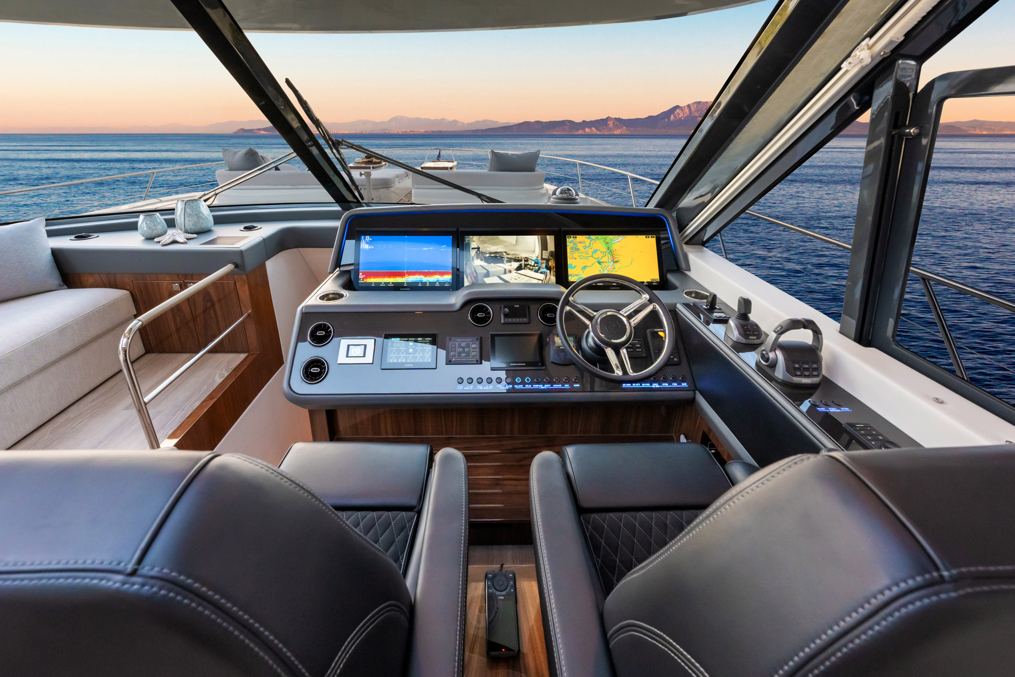 The commanding helm. Total control is at your fingertips and visibility is outstanding through the curved tempered glass windscreen.