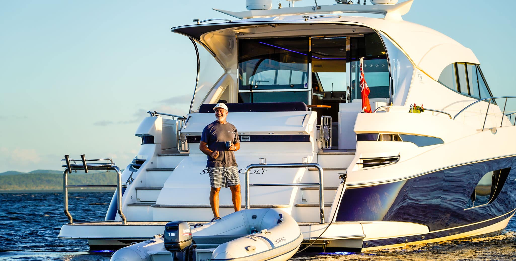 A happy adventurer aboard the Riviera 6000 Sport Yacht, Sierra Golf