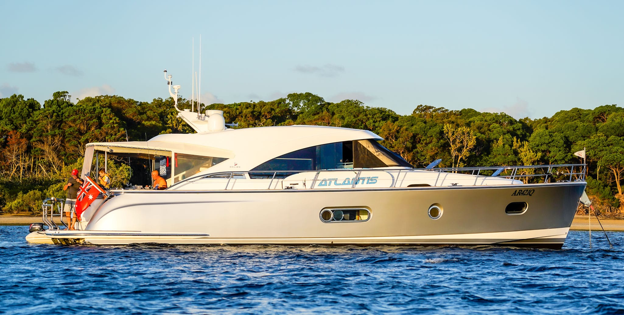 The crew of Silver Lady, Belize 52 Sedan, take the opportunity to prepare their rods for a spot of fishing